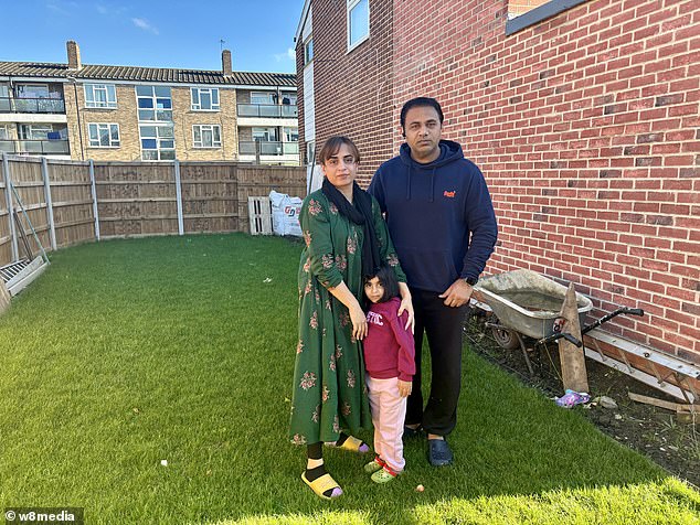 Mr Altaf (pictured, with his wife and daughter) accused Slough Council of 'trying to make his life difficult' in the row over the fence