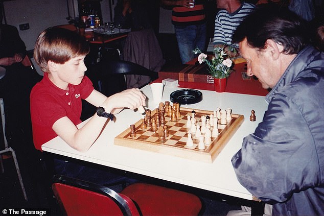 William, then aged 11, can be seen giving out Christmas presents, playing a game of chess (pictured) and listening intently as his mother speaks to those at the shelter