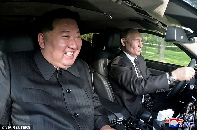 Russia's President Vladimir Putin and North Korea's leader Kim Jong Un ride an Aurus car in Pyongyang, North Korea in this image released by the Korean Central News Agency June 20