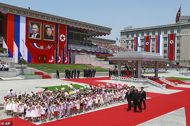 Russian President Vladimir Putin, left, and North Korea's leader Kim Jong Un, foreground right, attend the official welcome ceremony in the Kim Il Sung Square in Pyongyang, North Korea, on Wednesday, June 19, 2024