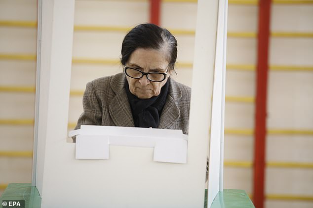 A Georgian woman casts her ballot in Tbilisi, Georgia, 26 October 2024