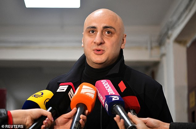 Nika Melia, a leader of the Coalition for Change, speaks to the media at a polling station during parliamentary elections in Tbilisi, Georgia October 26, 2024