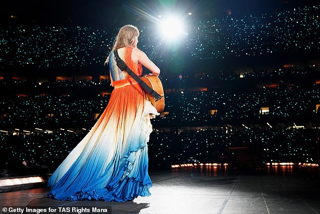 She unveiled the high-low V-neck gown with an orange bodice and white and blue skirt as she serenaded her 83,000 screaming fans at the Caesars Superdome