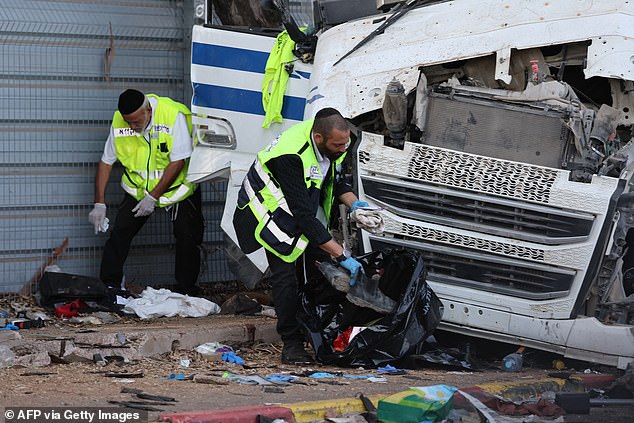 Israeli emergency responders clean the site after a driver rammed his truck into a crowd of people at a bus stop in Ramat Hasharon, north of Tel Aviv on October 27, 2024