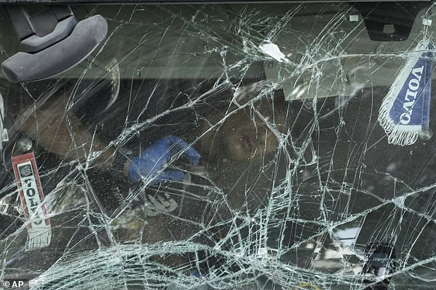 An Israeli police officer inspects inside the cabin of a truck that rammed into a bus stop near the headquarters of Israel's Mossad spy agency, wounding dozens of people, according to Israel's Magen David Adom rescue service near Tel Aviv, Israel