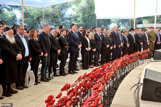 Officials attend a memorial ceremony marking the Hebrew calendar's one-year anniversary of the Hamas attack that sparked the ongoing war in Gaza, at the Mount Herzl military cemetery in Jerusalem, 27 October 2024