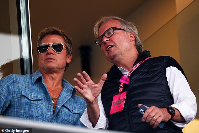 Brad Pitt chats with another VIP at the F1 Grand Prix of Mexico on Sunday