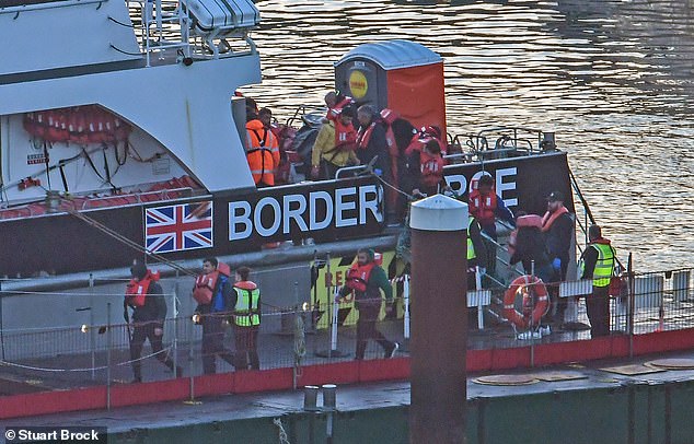 Border Force officials escort migrants into Dover Docks in Kent, United Kingdom on October 25, 2024