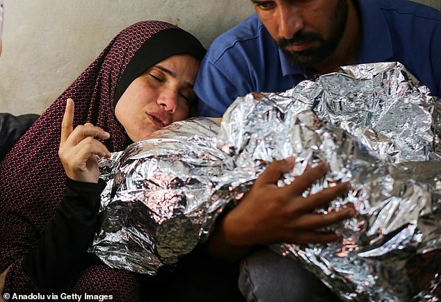 Palestinian child, who lost his life in a recent attack by the Israeli army on the Bureij Refugee Camp, Mohammed al Dahdouh's relatives express their grief at Al Aqsa Martyrs Hospital in Deir al-Balah, Gaza on October 28, 2024