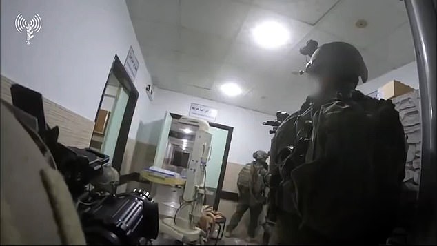 Israeli forces are seen stalking through hospital corridors with their weapons drawn