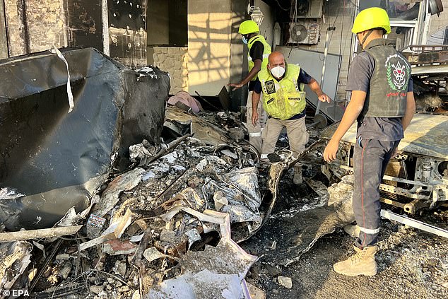 Search and rescue team members try to search possible victims at a damaged building after an Israeli airstrike, in Tyre, Lebanon, 28 October 2024