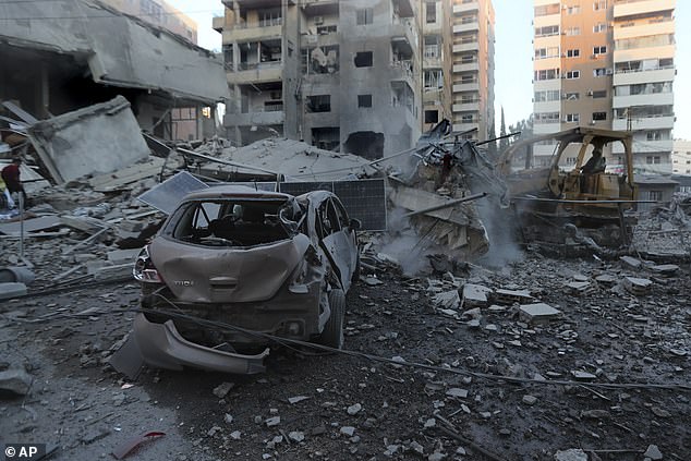 A rescue worker uses a bulldozer to remove the debris of destroyed buildings hit in Israeli airstrikes in Tyre, Lebanon, Monday, Oct. 28, 2024