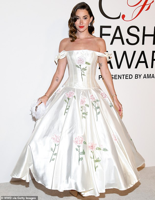 Madeleine White also embraced her inner princess in a white, off-the-shoulder gown that had pink-floral details embroidered onto the satin material