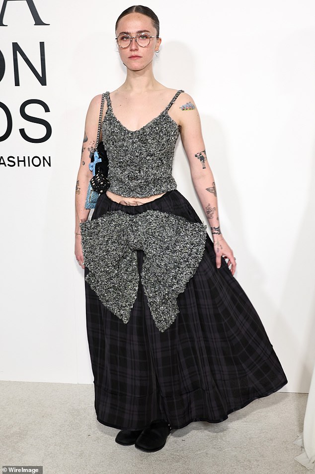 Ella Emhoff showed off her sense of style in a gray, cropped tank top as well as a dark plaid skirt that fell down towards her ankles