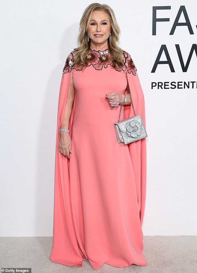 Kathy Hilton was radiant wearing a caped, pastel pink gown that had floral details embroidered around the neckline