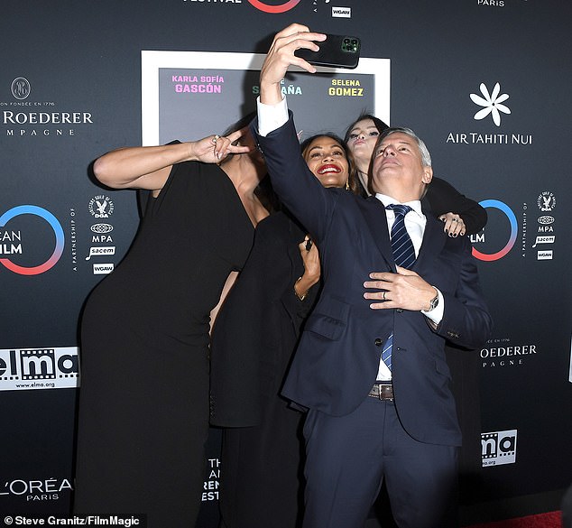 Tuesday's screening of Emilia Pérez was co-presented by Netflix, so the streaming giant's co-CEO Ted Sarandos (R) was on hand for selfie duty