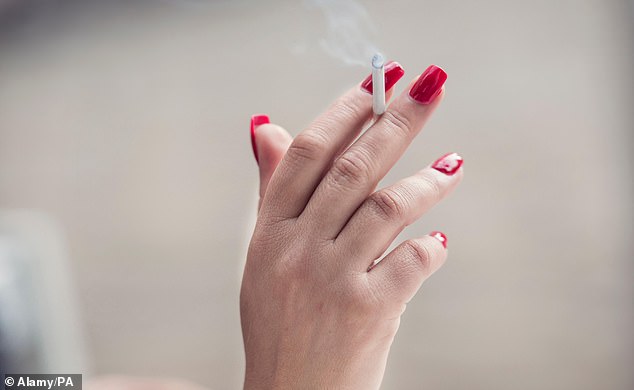 Tobacco duty will also go up under measures brought in by Rachel Reeves today. Pictured: A woman holding a lit cigarette