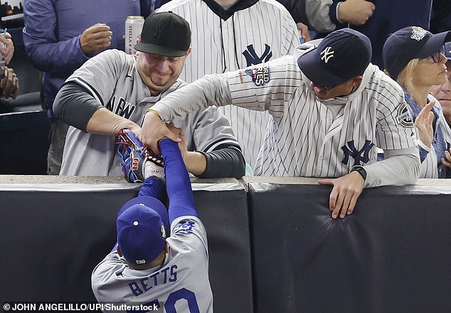 Two Yankees fans were ejected later after trying to grab a ball from Mookie Betts' glove