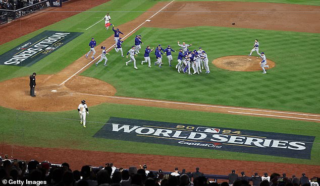 Dodgers players rush to the mound at Yankee Stadium to celebrate the historic victory