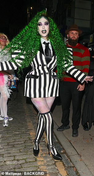 Maya went all out with her look, stepping out in a skimpy striped blazer dress that showed off her toned legs and was teamed with knee-high socks and heels