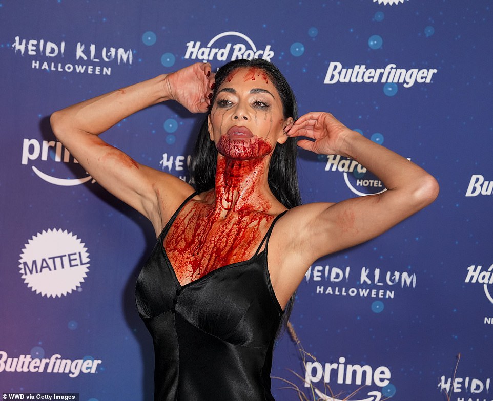 She wore a black slip dress and had fake blood around her mouth and running down her chest