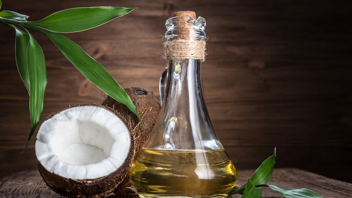 Coconut oil against wooden background