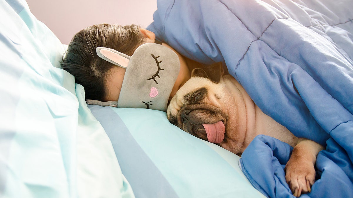 woman sleeping with dog