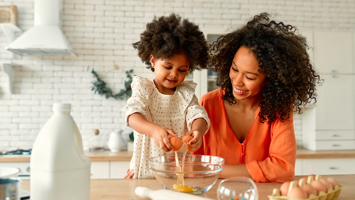 Kid and mom cooking in the kitchen