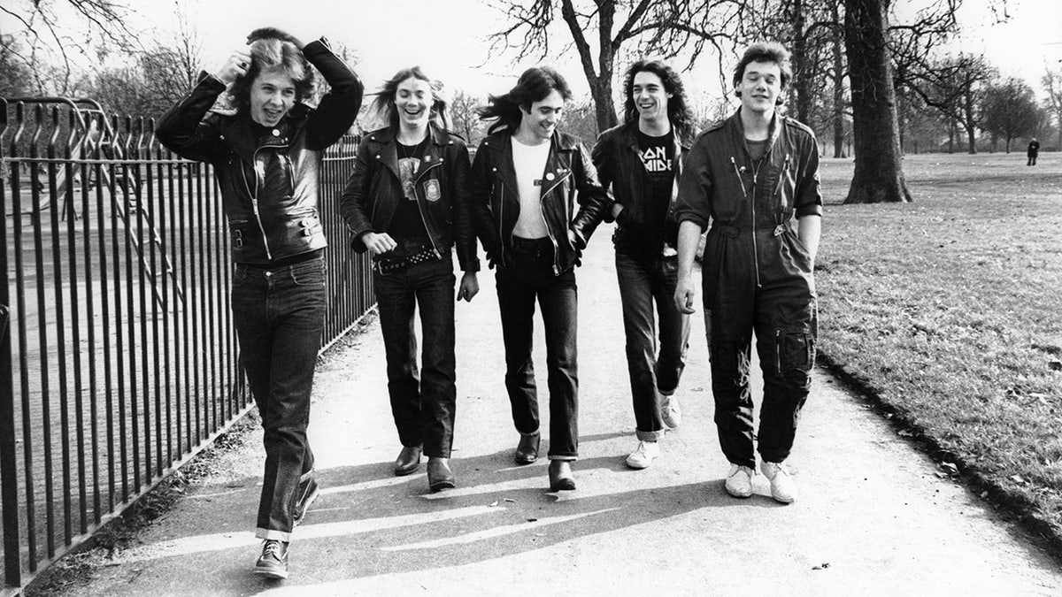 Dennis STRATTON and Steve HARRIS and Paul DI'ANNO and IRON MAIDEN and Dave MURRAY and Clive BURR; L-R: Clive Burr, Dave Murray, Steve Harris, Dennis Stratton, Paul Di'Anno - posed, group shot, walking