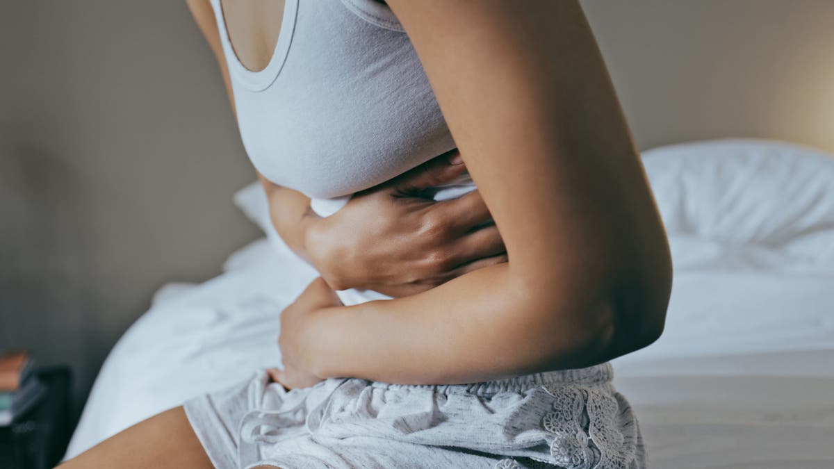 A woman holding stomach