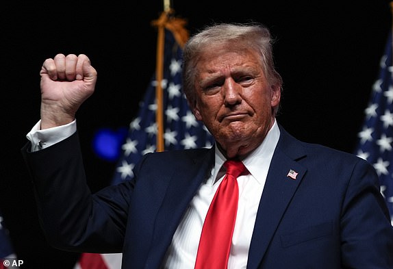 Republican presidential nominee former President Donald Trump gestures after a Tucker Carlson Live Tour show at Desert Diamond Arena, Thursday, Oct. 31, 2024, in Glendale, Ariz. (AP Photo/Julia Demaree Nikhinson)