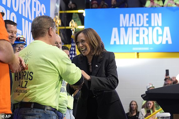 Democratic presidential nominee Vice President Kamala Harris greets a supporter before speaking at a campaign event in Janesville, Wis., Friday, Nov. 1, 2024. (AP Photo/Charles Rex Arbogast)