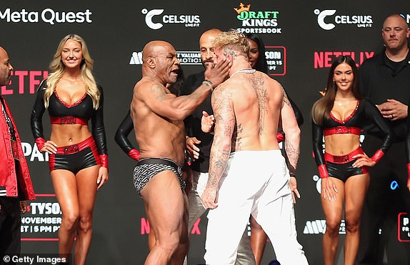 IRVING, TEXAS - NOVEMBER 14: Mike Tyson slaps Jake Paul as they face off during their ceremonial weigh-in at The Pavilion at Toyota Music Factory on November 14, 2024 in Irving, Texas. The two are scheduled to meet in a heavyweight bout on November 15 at AT&T Stadium in Arlington, Texas. (Photo by Christian Petersen/Getty Images)