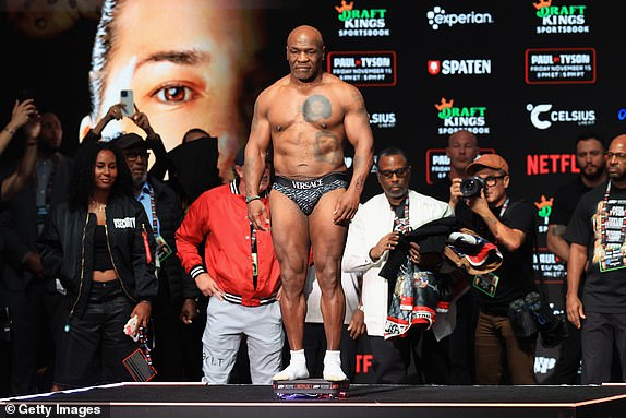 IRVING, TEXAS - NOVEMBER 14: Mike Tyson poses on the scale during his ceremonial weigh-in at The Pavilion at Toyota Music Factory on November 14, 2024 in Irving, Texas. Tyson is scheduled to meet Jake Paul in a heavyweight bout on November 15 at AT&T Stadium in Arlington, Texas. (Photo by Christian Petersen/Getty Images)