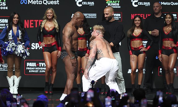 Nov 14, 2024; Irving, TX, USA;  Jake Paul and Mike Tyson face off during weigh-ins at the Toyota Music Factory the day before their fight.  Mandatory Credit: Kevin Jairaj-Imagn Images