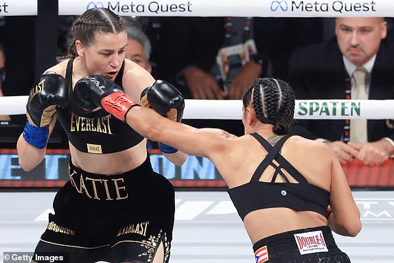 ARLINGTON, TEXAS - NOVEMBER 15: Amanda Serrano (R) punches Katie Taylor during their undisputed super lightweight women's title bout at AT&T Stadium on November 15, 2024 in Arlington, Texas. (Photo by Christian Petersen/Getty Images)