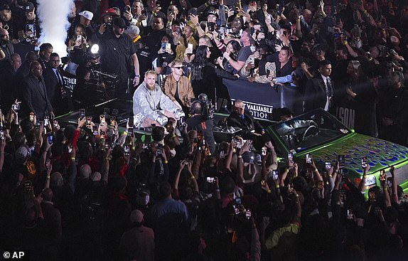 Jake Paul is driven to the ring before a heavyweight boxing match against Mike Tyson, Friday, Nov. 15, 2024, in Arlington, Texas. (AP Photo/Julio Cortez)