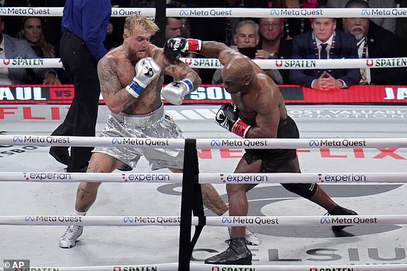 Mike Tyson throws a right at Jake Paul during their heavyweight boxing match, Friday, Nov. 15, 2024, in Arlington, Texas. (AP Photo/Julio Cortez)