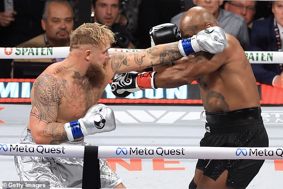 ARLINGTON, TEXAS - NOVEMBER 15: Jake Paul (L) punches Mike Tyson during their heavyweight bout at AT&T Stadium on November 15, 2024 in Arlington, Texas. (Photo by Christian Petersen/Getty Images) ***BESTPIX***