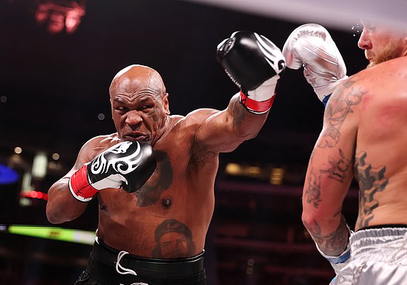 ARLINGTON, TEXAS - NOVEMBER 15: (L-R) Mike Tyson and Jake Paul fight during LIVE On Netflix: Jake Paul vs. Mike Tyson at AT&T Stadium on November 15, 2024 in Arlington, Texas. (Photo by Al Bello/Getty Images for Netflix Â© 2024)