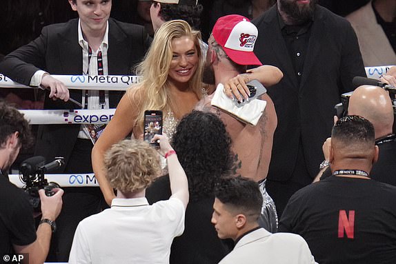 Jake Paul embraces girlfriend Jutta Leerdam after defeating Mike Tyson during their heavyweight boxing match, Friday, Nov. 15, 2024, in Arlington, Texas. (AP Photo/Julio Cortez)