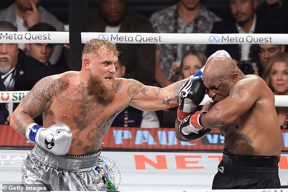 ARLINGTON, TEXAS - NOVEMBER 15: Jake Paul (L) punches Mike Tyson during their heavyweight bout at AT&T Stadium on November 15, 2024 in Arlington, Texas. (Photo by Christian Petersen/Getty Images)