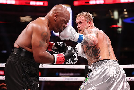 ARLINGTON, TEXAS - NOVEMBER 15: (L-R) Mike Tyson and Jake Paul fight during LIVE On Netflix: Jake Paul vs. Mike Tyson at AT&T Stadium on November 15, 2024 in Arlington, Texas. (Photo by Al Bello/Getty Images for Netflix Â© 2024)