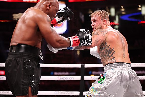 ARLINGTON, TEXAS - NOVEMBER 15: (L-R) Mike Tyson and Jake Paul fight during LIVE On Netflix: Jake Paul vs. Mike Tyson at AT&T Stadium on November 15, 2024 in Arlington, Texas. (Photo by Al Bello/Getty Images for Netflix Â© 2024)