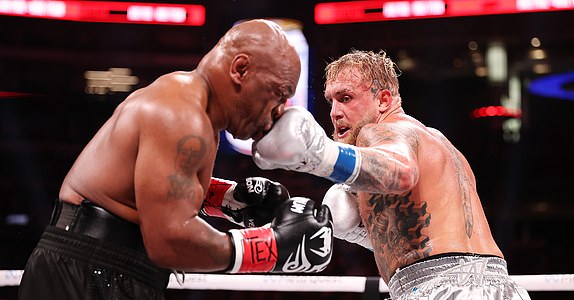 ARLINGTON, TEXAS - NOVEMBER 15: (L-R) Mike Tyson and Jake Paul fight during LIVE On Netflix: Jake Paul vs. Mike Tyson at AT&T Stadium on November 15, 2024 in Arlington, Texas. (Photo by Al Bello/Getty Images for Netflix Â© 2024)