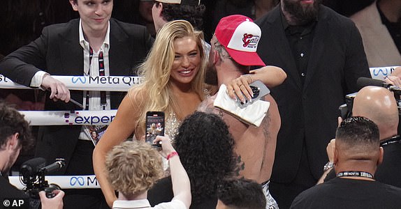 Jake Paul embraces girlfriend Jutta Leerdam after defeating Mike Tyson during their heavyweight boxing match, Friday, Nov. 15, 2024, in Arlington, Texas. (AP Photo/Julio Cortez)