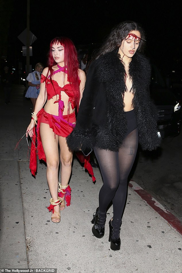 Charli XCX and Rosalia turned up the heat in their own revealing outfits, with the hitmaker slipping into a daring red ripped dress