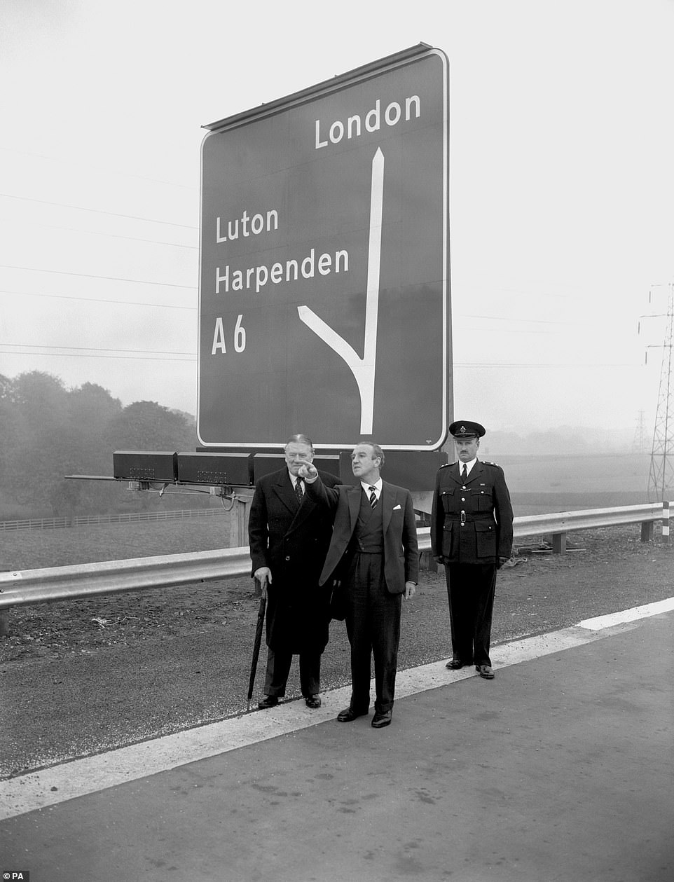 Ernest Marples, the Minister of Transport (pointing) discusses Britain's first motorway with Sir Owen Williams