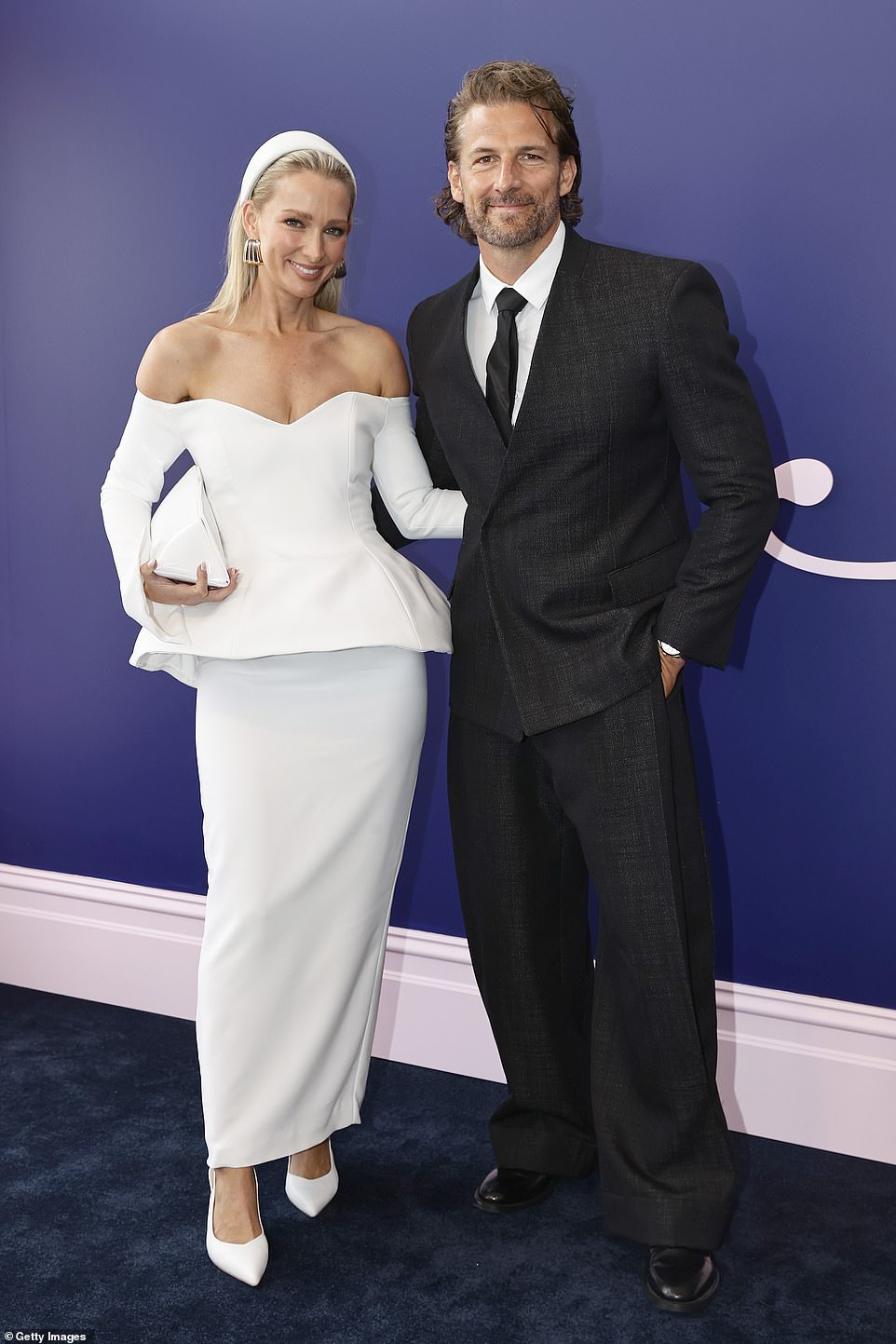 Anna Heinrich, 37, (left) and Tim Robards, 42, (right) wore contrasting looks as they graced the Birdcage at Flemington Racecourse