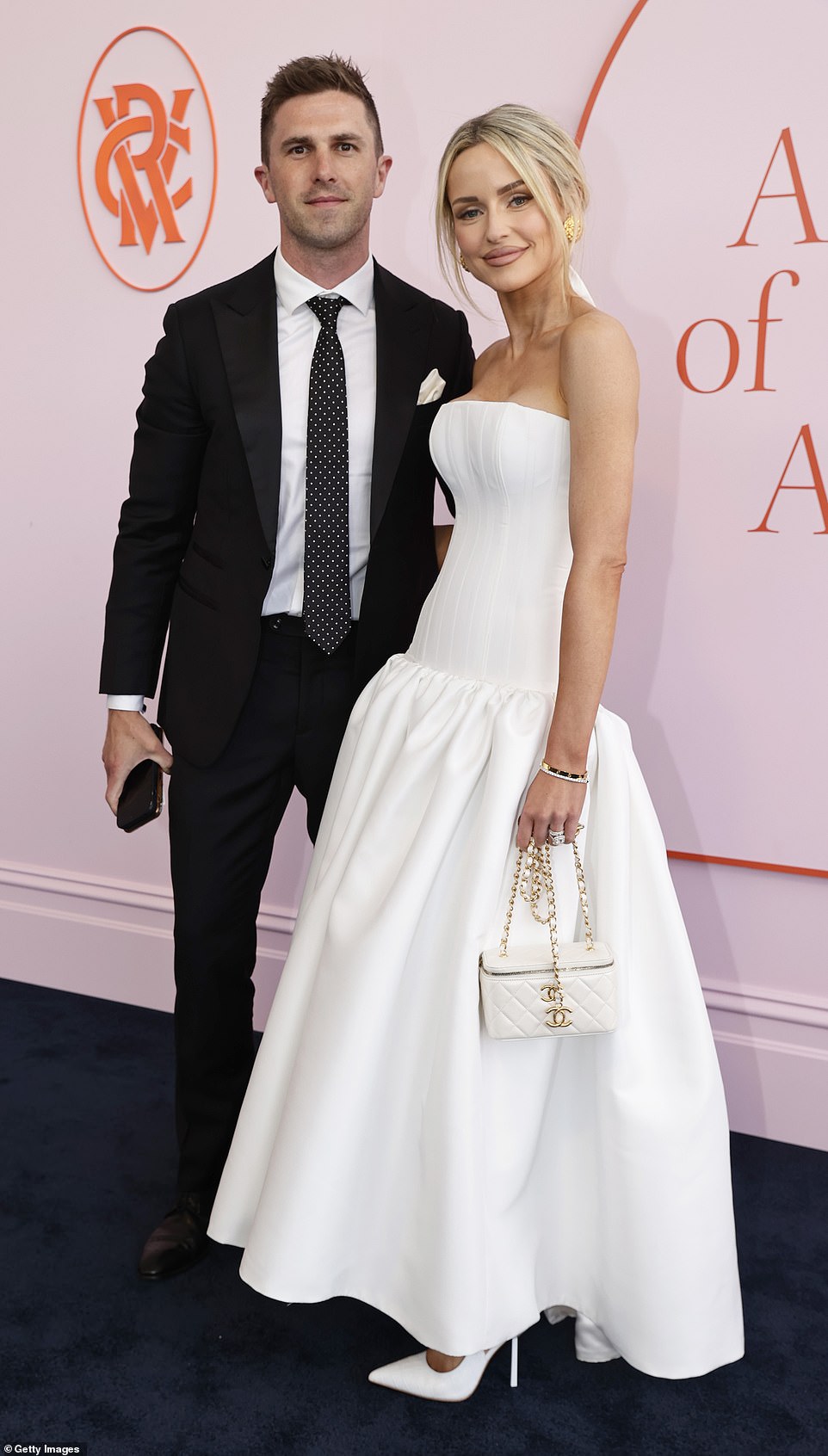 AFL WAG Jessie Murphy (right) flaunted her figure in a white corset bodice alongside partner Marc (left)